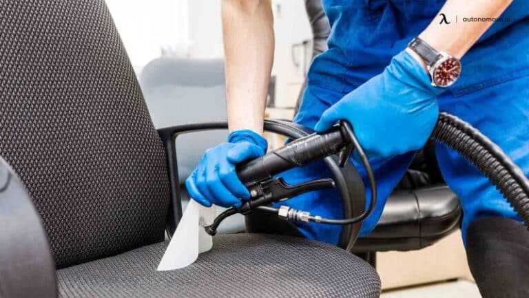 Man professionally cleaning a chair with a hand held device