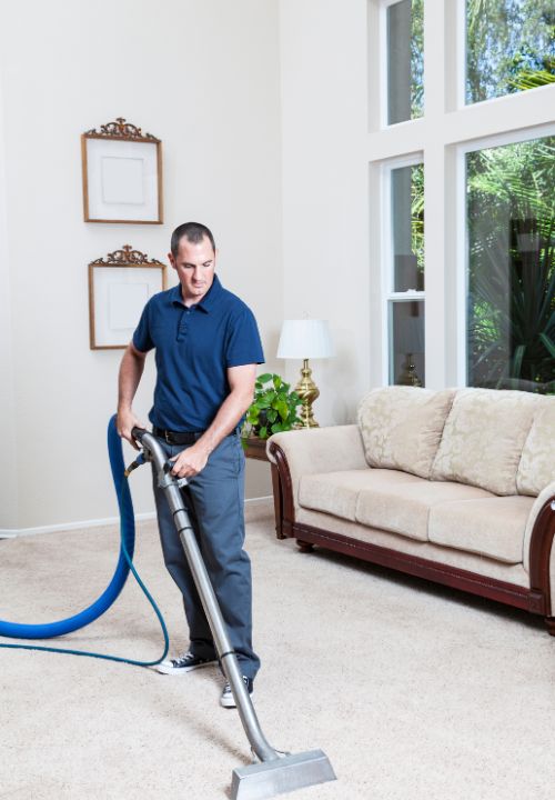 man in uniform cleaning carpet